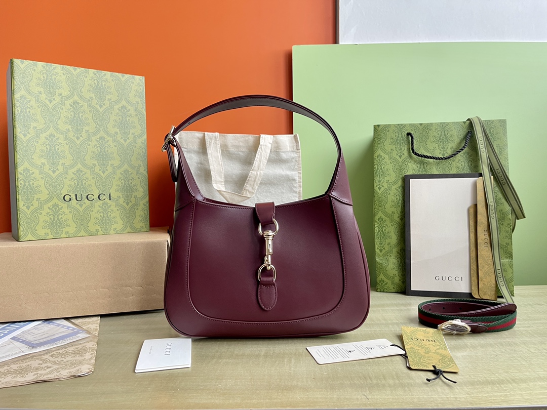 Nº de modelo: 782849 Tamaño: 27,5/19/4 P1900 Este nuevo bolso bandolera Gucci Jackie está confeccionado con las mejores pieles para mostrar la artesanía, la forma de media luna y el diseño elegante de los bolsos bandolera clásicos de la marca. La combinación de herrajes en tono dorado claro, ribetes de piel y correas complementarias con cincha roja y verde aportan más posibilidades de uso a este pequeño bolso bandolera Gucci Jackie confeccionado en la clásica piel roja Gucci Rosso Ancora de la marca. La combinación de herrajes en tono dorado claro, ribetes de piel y correas complementarias con cincha roja y verde aportan más posibilidades de uso a este pequeño bolso bandolera Gucci Jackie confeccionado en la clásica piel roja Gucci Rosso Ancora de la marcaPiel Gucci Rosso AncoraHerrajes en tono dorado claroForro de pielInterior: un bolsillo con cremallera decorado con la insignia de GucciAsas superiores con cremallera (18 cm de altura)Correa bandolera de cincha extraíble (52 cm de altura)Cierre de gancho y lazo-Fábrica de alto impacto