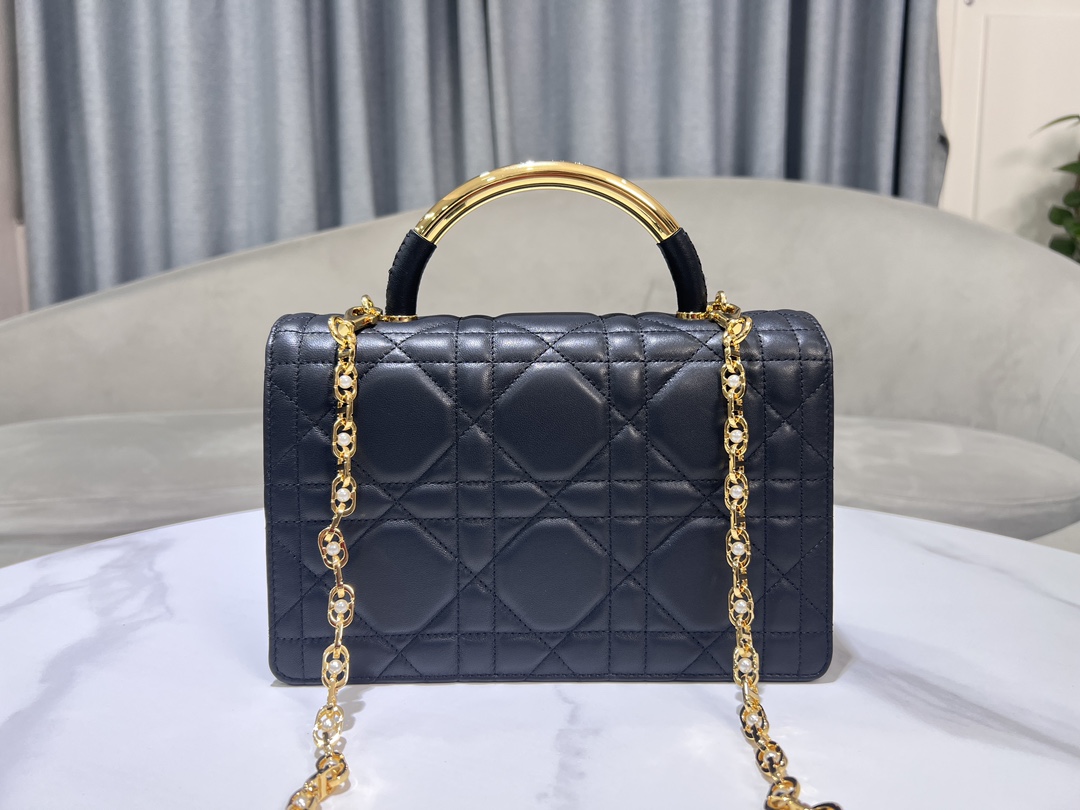 Large P1400The Dior Ange handbag, new to the Fall 2014 Ready-to-Wear collection, opens Dior's new collection with an elegantly chic aesthetic crafted in black leather with oversized rattan check stitching and stiffened, vintage gold-tone metal top handles engraved with the Christian Dior Paris logoFlap flap decorated with a resin-beaded, embellished CD claspSewn in triangular lining with two spacious compartments and a slit pocket. Triangular lined silhouette with two spacious compartments and a slip pocket for storing everyday essentialsElegant design in a medium sizeAdjustable, detachable chain shoulder strap made of gold-tone metal with resin beadwork embellishmentsCan be carried in a handheld position, over the shoulder or across the bodyCode: 4402Measurements: 25x 16x 8 cm (L x H x W)-High-Fashion Factory