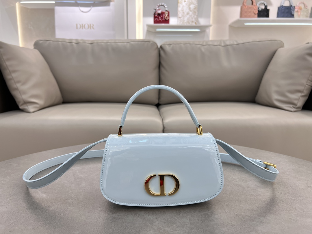 Small 30 Montaigne Avenue Top Handle White Patent Cowhide No. M9370UNQA This 30 Montaigne Avenue Top Handle is a new addition to the Winter 2014 Ready-to-Wear collection, showcasing elegance and modern style in beautifully crafted, durable and richly textured blue patent cowhide. Dior's craftsmanship is evident on the flap embellished with a vintage gold-tone metal CD logoDouble compartment with sewn-in triangular liningAn additional back pocket for added practicalitySmaller version with leather top handles and adjustable, removable shoulder strapCan be carried by hand, over the shoulder or cross-bodyFront embellished with the CD logoFlap closureLeather top handlesAdjustable, removable leather shoulder strapTwo interior compartments2 internal slit pocketsBack pocket with dust bag PouchMade in ItalyModel No.: 6530Size: 19 x 9 x 8-High Fake Factory