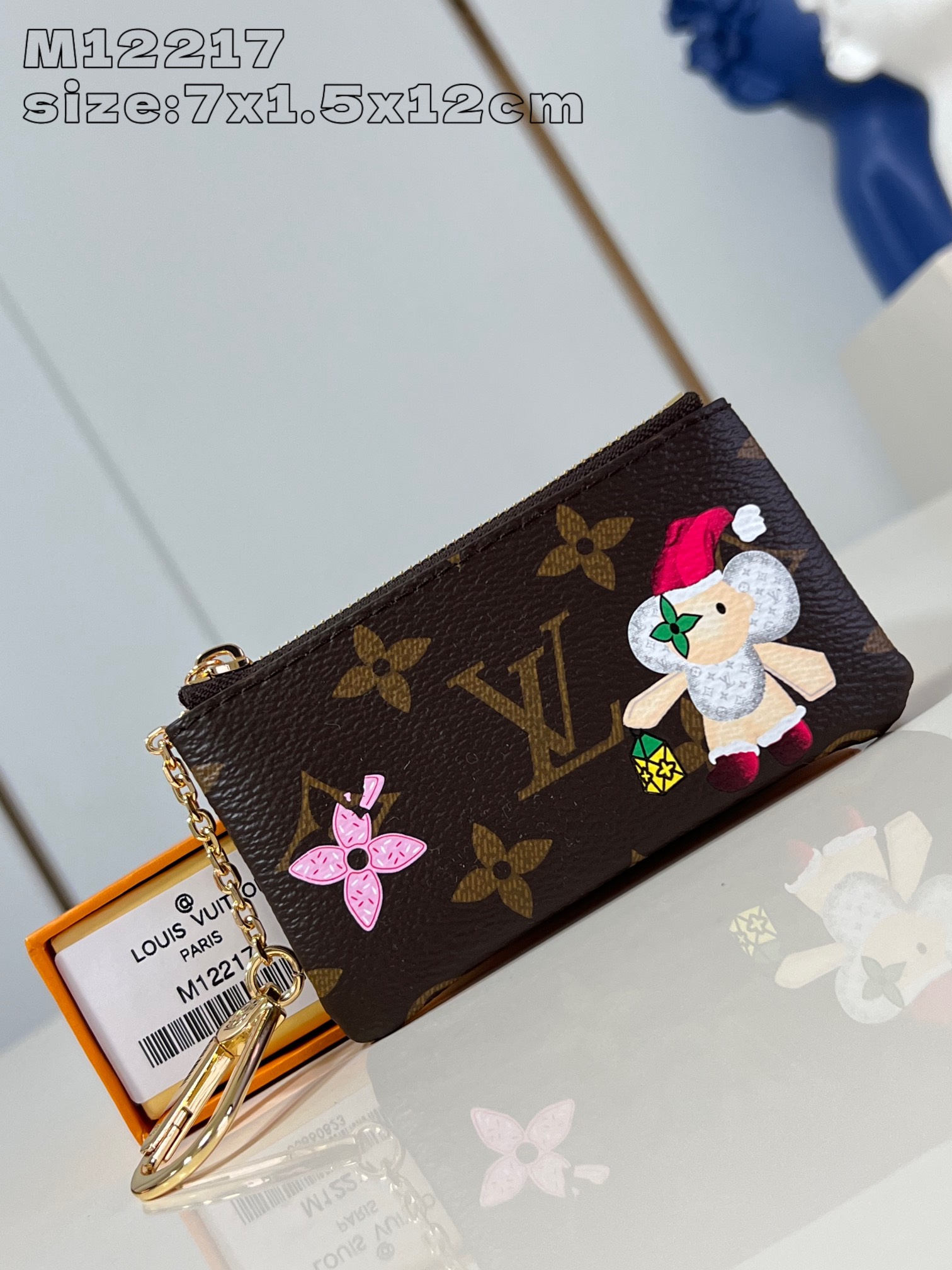 M12217 From the Candy Factory collection, this key case makes a collector's gift for the festive season by dressing the brand's mascot, Vivienne, in festive attire and paying homage to the holiday season with tasty seasonal candies. Monogram canvas shapes the key ring and Vivienne shaped zipper complete the detailing, along with eye-catching metal pieces 7 x 1.5 x 12 cm (H x W x D). length)