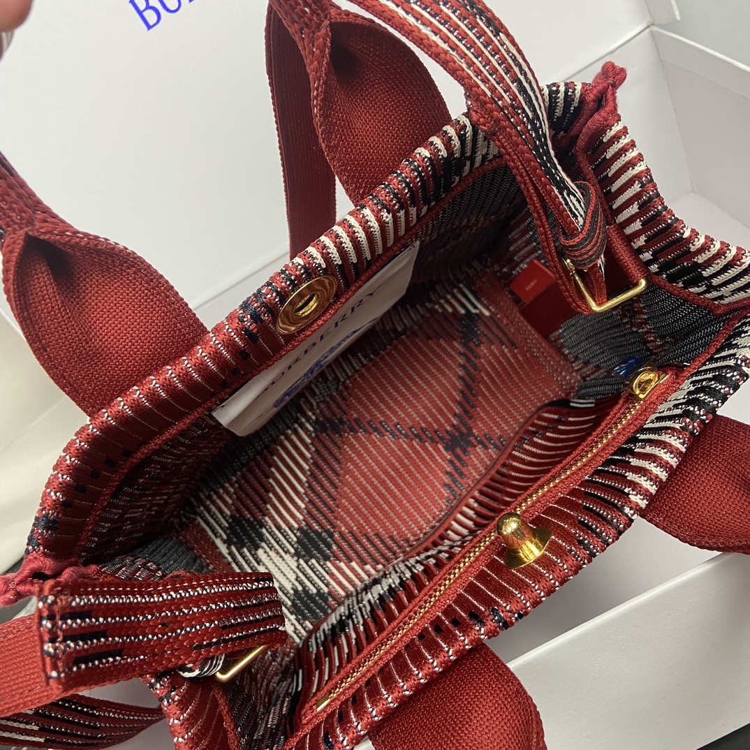 Burberry Red Tote Bag Size: 25 x 11 x 22cm. Minimum vertical wearable length of shoulder strap: 45cm. Maximum vertical wearable length of shoulder strap: 48cm. Soft and supple tote bag crafted in Italian knit and decorated with Burberry check pattern in a lightweight, unlined design with engraved Equestrian Knight logo (EKD) snap closure.- Detachable crossbody strap- Snap button closure- Zippered inside pocket- Brushed metal hardware- Engraved equestrian rider logo on closure