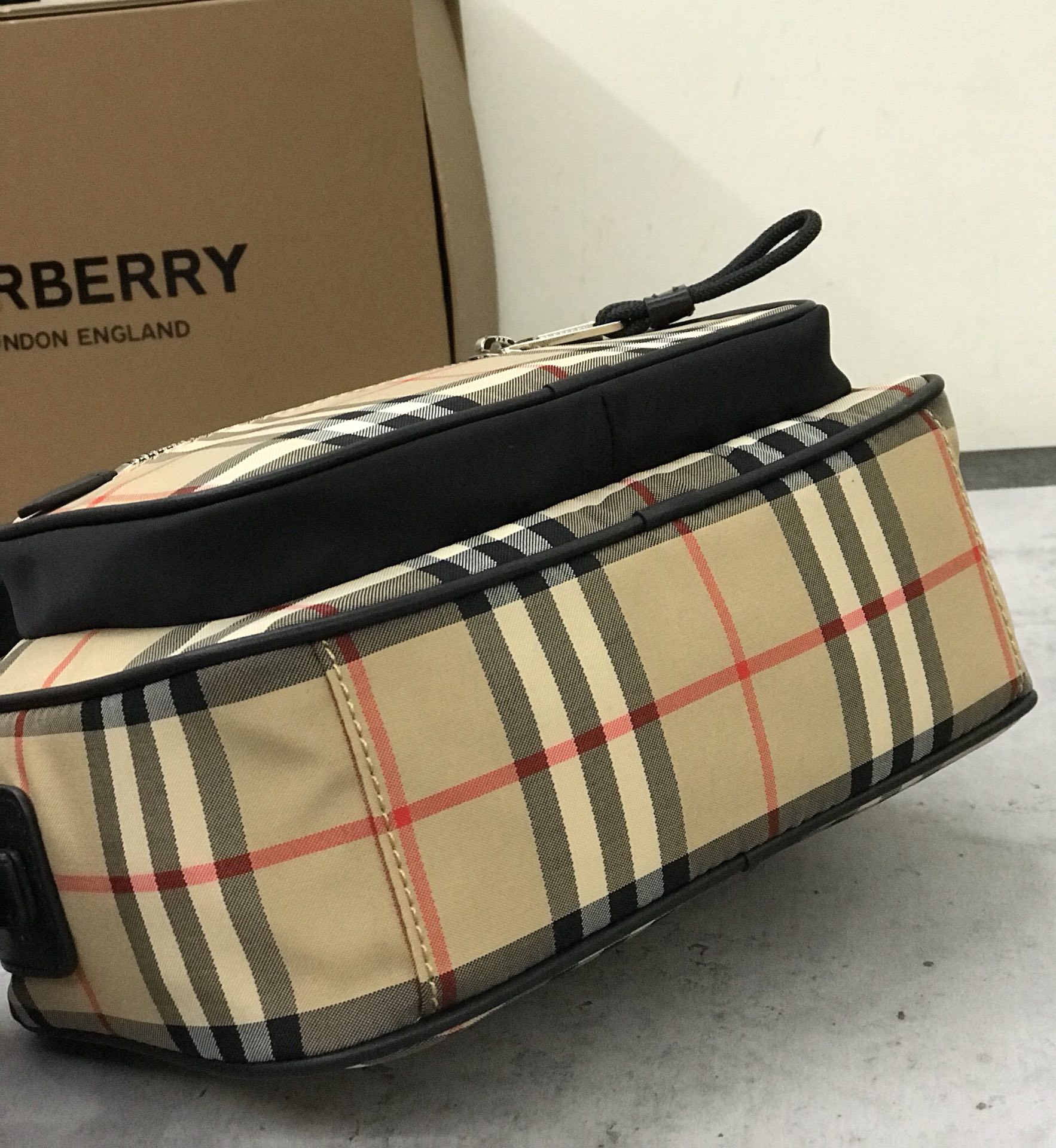 Burberry's smart slouchy backpack is crafted from vintage plaid bonded cotton with fine leather trims and jacquard worsted branding logo and features adjustable mesh nylon straps for slouchy or shoulder carry. 22.5 x 8.2 x 14.5cm!