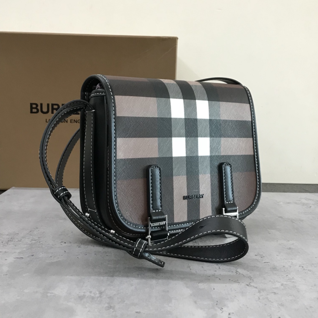 Burberry's sleek messenger bag is updated in checkered eco-canvas, which is made from renewable resources and requires less water and generates less carbon dioxide than traditional coated canvas. The bag is printed with a logo and trimmed with a striped leather trim and an adjustable shoulder strap. 1 external pocket with hidden magnetic closure; 1 internal zipped pocket; 1 internal slit pocket. Fold-over front flap with snap and buckle closure. Hand-painted edges. Shiny metal hardware. Burberry monogrammed logo on front.22x19x7 p900