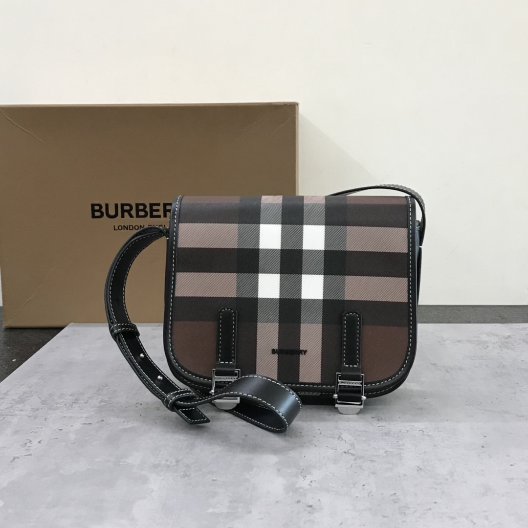 Burberry's sleek messenger bag is updated in checkered eco-canvas, which is made from renewable resources and requires less water and generates less carbon dioxide than traditional coated canvas. The bag is printed with a logo and trimmed with a striped leather trim and an adjustable shoulder strap. 1 external pocket with hidden magnetic closure; 1 internal zipped pocket; 1 internal slit pocket. Fold-over front flap with snap and buckle closure. Hand-painted edges. Shiny metal hardware. Burberry monogrammed logo on front.22x19x7 p900