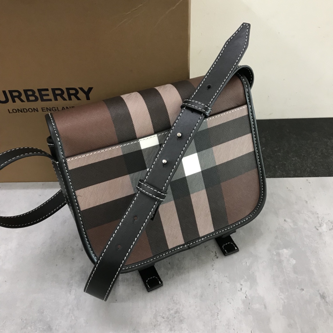 Burberry's sleek messenger bag is updated in checkered eco-canvas, which is made from renewable resources and requires less water and generates less carbon dioxide than traditional coated canvas. The bag is printed with a logo and trimmed with a striped leather trim and an adjustable shoulder strap. 1 external pocket with hidden magnetic closure; 1 internal zipped pocket; 1 internal slit pocket. Fold-over front flap with snap and buckle closure. Hand-painted edges. Shiny metal hardware. Burberry monogrammed logo on front.22x19x7 p900