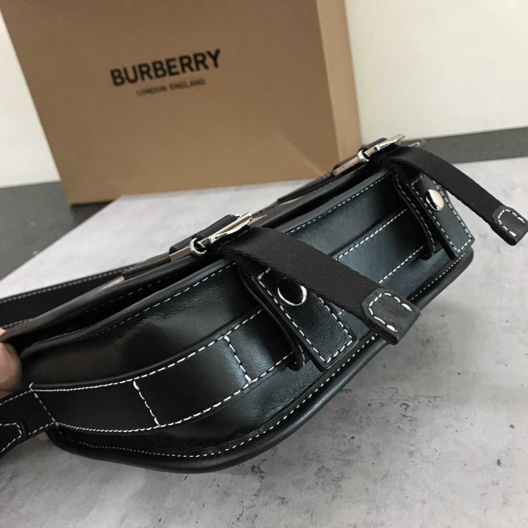 A elegante mala de mensageiro da Burberry foi renovada em lona ecológica axadrezada, que é fabricada a partir de recursos renováveis e requer menos água e produz menos dióxido de carbono do que a lona revestida tradicional. A mala é impressa com um logótipo e rematada com um acabamento em pele às riscas. Aba frontal dobrável com fecho de mola e fivela. Rebordos pintados à mão. Ferragens em metal brilhante. Logótipo com monograma Burberry na frente.22x19x7 p900