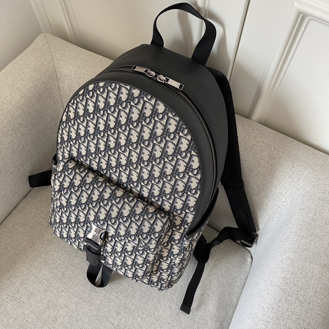 This backpack is the latest addition to this season's Dior Explorer collection, which combines the spirit of haute couture with the richness of practicality. Crafted in beige and black jacquard, it is adorned with an Oblique print and black grained cowhide leather side "DIOR" leather patches. Pocket and two side pockets for added sophisticationPadded shoulder strap and metal ring for keys or D-Touch clutch bag can be worn with a wide range of casual items as a finishing touchModel no. 2011Size 30-42-14.5Beige and black Oblique printMetal cladding on frontBrass "DIOR" logo on side DIOR" patch on the side "DIOR" patch on the inside "DIOR" patch on the inside "DIOR" logo nylon "CHRISTIAN DIOR" logo jacquard handles Aluminum buckle with two-way zipper closure  "DIOR" logo on top "CHRISTIAN DIOR" logoNylon jacquard handlesFront and side pocketsIncludes dust bagMade in Italy191701300-High quality bag