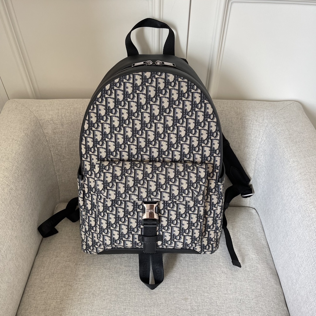 This backpack is the latest addition to this season's Dior Explorer collection, which combines the spirit of haute couture with the richness of practicality. Crafted in beige and black jacquard, it is adorned with an Oblique print and black grained cowhide leather side "DIOR" leather patches. Pocket and two side pockets for added sophisticationPadded shoulder strap and metal ring for keys or D-Touch clutch bag can be worn with a wide range of casual items as a finishing touchModel no. 2011Size 30-42-14.5Beige and black Oblique printMetal cladding on frontBrass "DIOR" logo on side DIOR" patch on the side "DIOR" patch on the inside "DIOR" patch on the inside "DIOR" logo nylon "CHRISTIAN DIOR" logo jacquard handles Aluminum buckle with two-way zipper closure  "DIOR" logo on top "CHRISTIAN DIOR" logoNylon jacquard handlesFront and side pocketsIncludes dust bagMade in Italy191701300-High quality bag