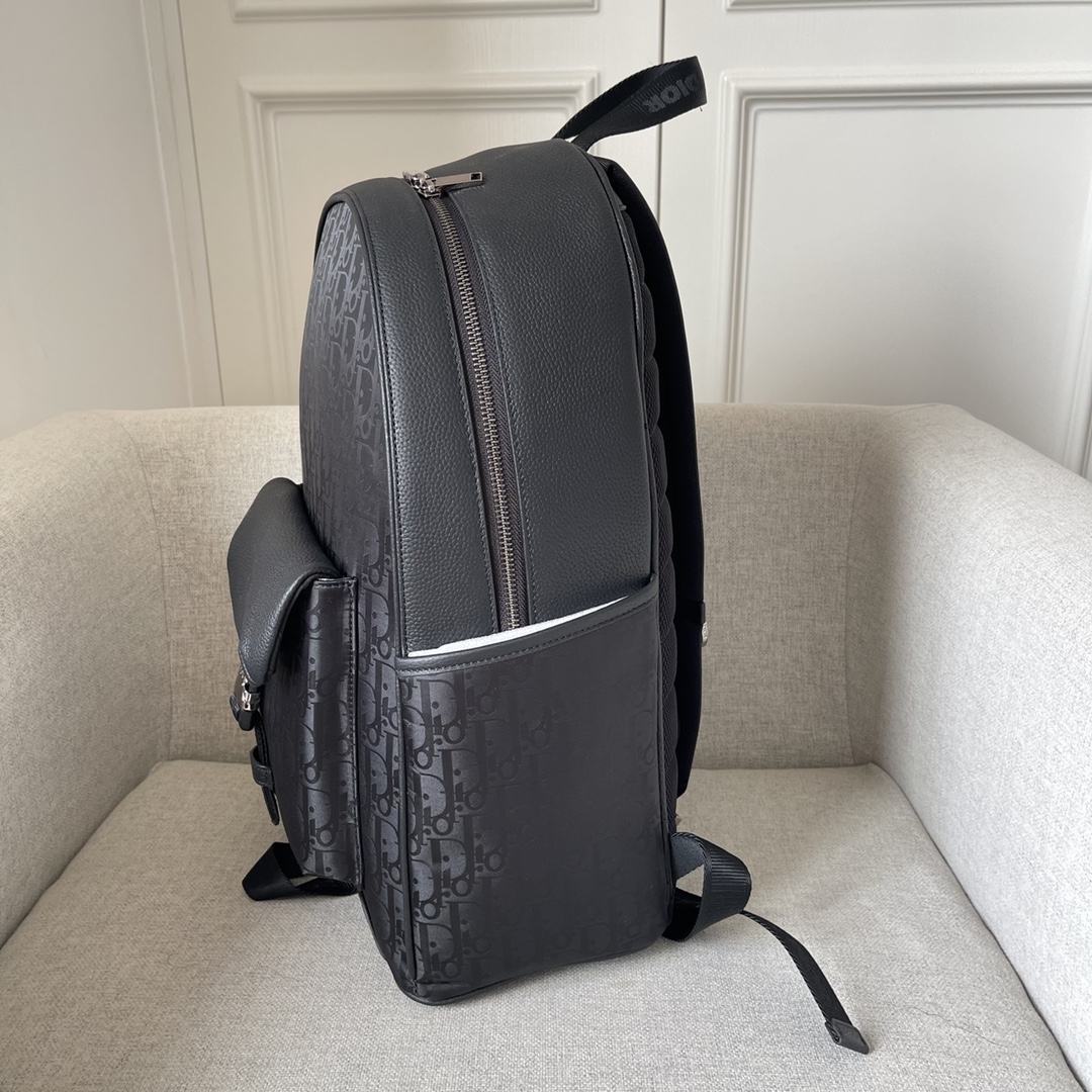 This backpack is the latest addition to this season's Dior Explorer collection, which combines the spirit of haute couture with practicality. Crafted in black technical fabric with an Oblique Mirage print and black grained cowhide leather with DIOR leather patches on the sides, the large main compartment is complemented by a padded front flap pocket with aluminum clasp and two side pockets, and is finished with padded shoulder straps and metal rings. Easy to carry keys or D-Touch clutch can be worn with a wide range of casual items as a finishing touch Model 2012 Black Tech Fabric Oblique Mirage Print Oblique Mirage Print features water-resistant tech fabric with reflective effects Oblique Print elevates style and craftsmanship This GRS certified (Global Recycling Standard) material is made of 100% ECONOMY® and is available in a wide range of colors and materials. Made from 100% ECONYL yarn, a recycled and recyclable nylon fiberBlack grained cowhideLeatherMetal overlay on frontBrass DIOR logo on sideDIOR patch on insideDIOR logoNylon CHRISTIAN DIOR logoJacquard handleDIOR logoAluminum buckleBi-directional zipper closureDIOR logoPadded meshFabricAdjustable shoulder straps with Metal ringsReinforced back with padded mesh fabricMatching DIOR logoFront and side pocketsDust bag includedMade in Italy191701300-High quality bag