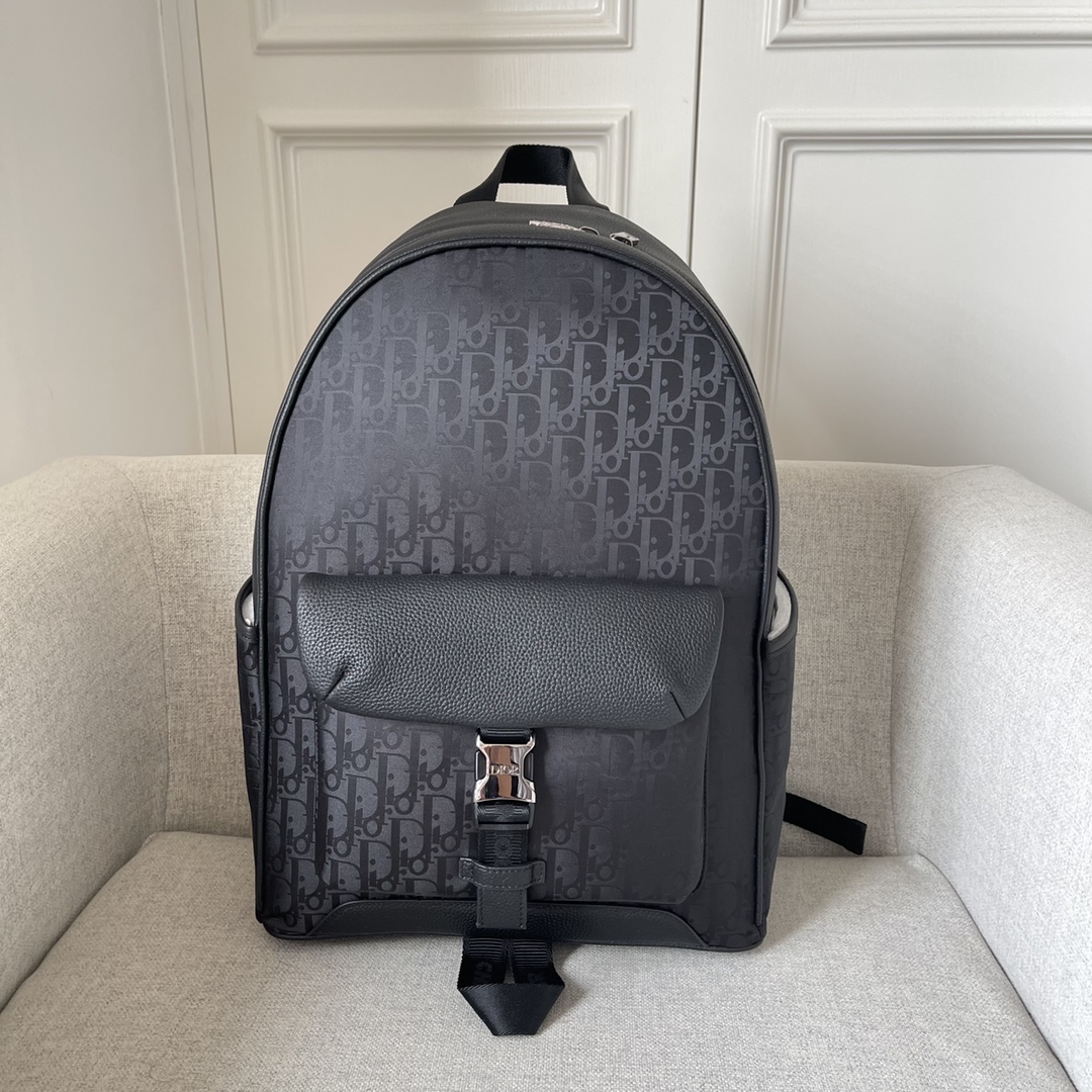 This backpack is the latest addition to this season's Dior Explorer collection, which combines the spirit of haute couture with practicality. Crafted in black technical fabric with an Oblique Mirage print and black grained cowhide leather with DIOR leather patches on the sides, the large main compartment is complemented by a padded front flap pocket with aluminum clasp and two side pockets, and is finished with padded shoulder straps and metal rings. Easy to carry keys or D-Touch clutch can be worn with a wide range of casual items as a finishing touch Model 2012 Black Tech Fabric Oblique Mirage Print Oblique Mirage Print features water-resistant tech fabric with reflective effects Oblique Print elevates style and craftsmanship This GRS certified (Global Recycling Standard) material is made of 100% ECONOMY® and is available in a wide range of colors and materials. Made from 100% ECONYL yarn, a recycled and recyclable nylon fiberBlack grained cowhideLeatherMetal overlay on frontBrass DIOR logo on sideDIOR patch on insideDIOR logoNylon CHRISTIAN DIOR logoJacquard handleDIOR logoAluminum buckleBi-directional zipper closureDIOR logoPadded meshFabricAdjustable shoulder straps with Metal ringsReinforced back with padded mesh fabricMatching DIOR logoFront and side pocketsDust bag includedMade in Italy191701300-High quality bag