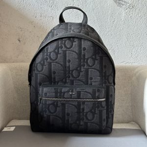 The Rider backpack is a simple, classic, collegiate style with a vibrant twist, crafted in oversized black Oblique print fabric and featuring a new interpretation of the classic Dior motif with smooth cowhide leather detailing and the Dior logo on the front to elevate the look. Ideal for everyday styling, the Rider is finished off with a two-way zipper closure, a large zippered pocket on the front, and adjustable, padded straps. Ideal for everyday stylingOversized Oblique print in blackMetal-coated brass Dior logo at frontEmbossed Dior logo at interiorTwo-way zipper closureAdjustable padded shoulder strapLeather top handleQuilted technical knit reinforcement on back side of handbagDior logo embossed on front zipper pocket and interior patch pocketInterior dust bagMade in ItalyModel No. 8962Size 30-42-15191701300