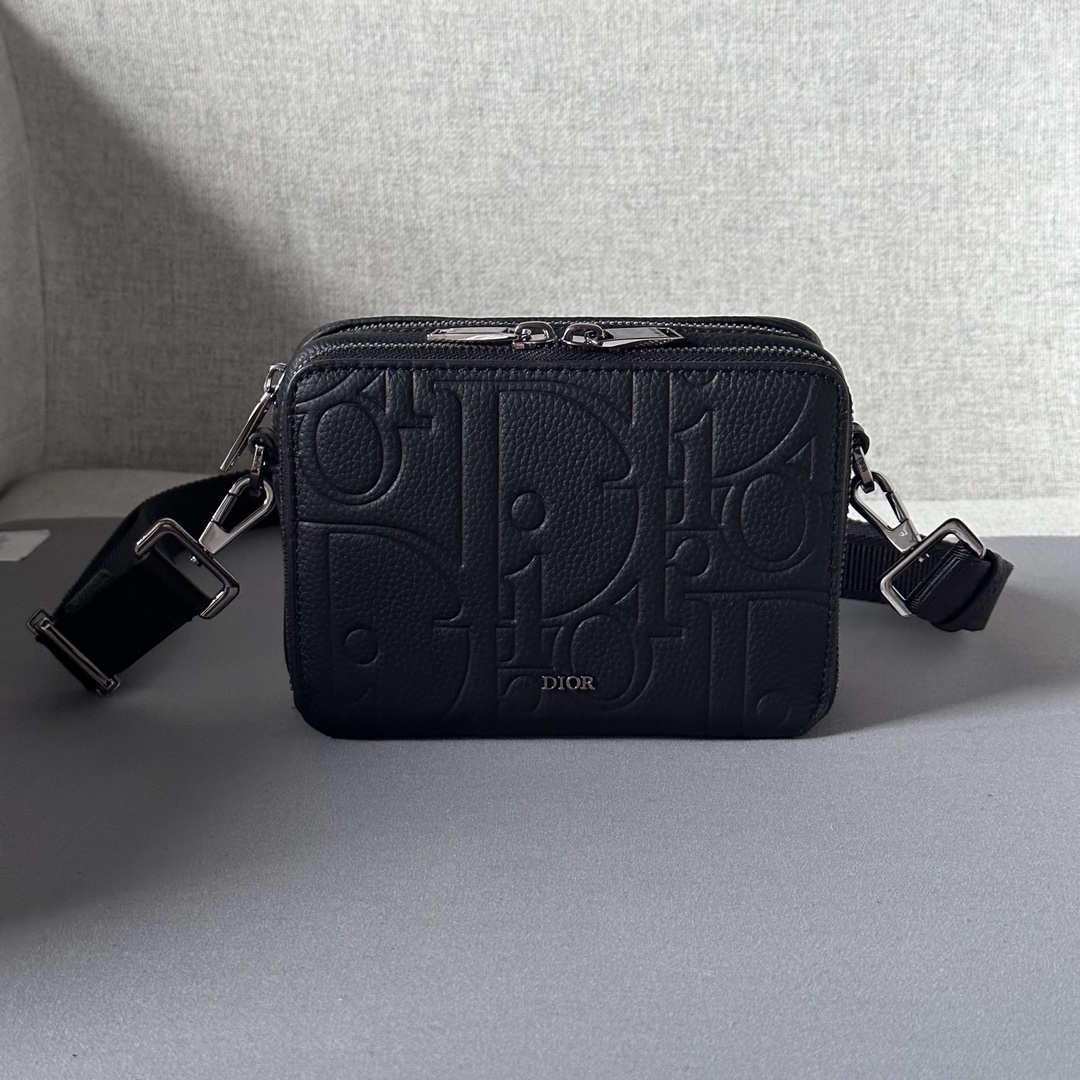 Elegant and practical, this zipped clutch with shoulder strap can organize your daily essentials Dior Gravity print leather is embossed with a classic pattern on black cowhide leather The Dior logo on the front is a tribute to the craftsmanship of the Dior atelier The top features a two-way zipper closure and zipped pockets with triangular lining sewn in to enhance the look and feel of the bag. Adjustable, detachable shoulder strap with Christian Dior logoShoulder, crossbody or clutchInterior in smooth cowhide leather and nylonDouble zipped compartmentInterior slots for 4 cardsModel no. 803617-12.5-6Adjustable, detachable Christian Dior nylon jacquard shoulder strap with lobster claspMetal cladding on frontBrass Dior logo on insideDior logo embossed on inside Embossed logoDust bag includedMade in Europe 19170900-High quality bag