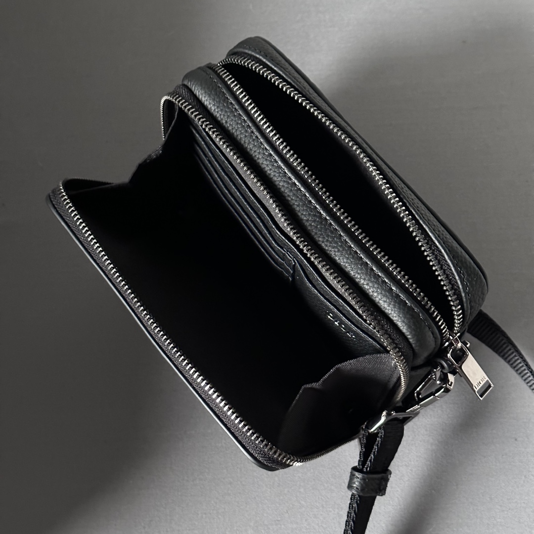 Elegant and practical, this zipped clutch with shoulder strap can organize your daily essentials Dior Gravity print leather is embossed with a classic pattern on black cowhide leather The Dior logo on the front is a tribute to the craftsmanship of the Dior atelier The top features a two-way zipper closure and zipped pockets with triangular lining sewn in to enhance the look and feel of the bag. Adjustable, detachable shoulder strap with Christian Dior logoShoulder, crossbody or clutchInterior in smooth cowhide leather and nylonDouble zipped compartmentInterior slots for 4 cardsModel no. 803617-12.5-6Adjustable, detachable Christian Dior nylon jacquard shoulder strap with lobster claspMetal cladding on frontBrass Dior logo on insideDior logo embossed on inside Embossed logoDust bag includedMade in Europe 19170900-High quality bag