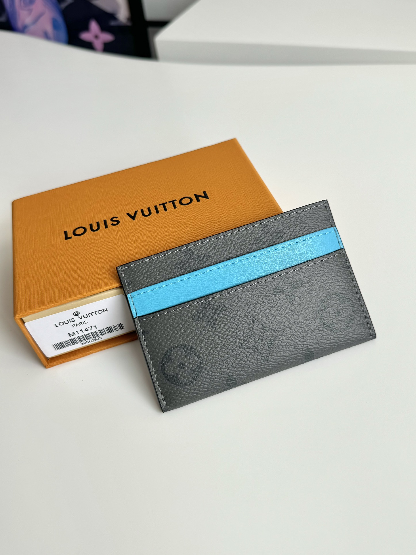 P220 M11471 This card holder is made of Monclerogram Eclipse Reverse canvas giving the Monclerogram pattern an elegant faded look and feel showing Pharrell Williams' fresh take on a classic element with a vintage Marque L.Vuitton Déposée logo on the front again paying tribute. Size: 11 x 7cm