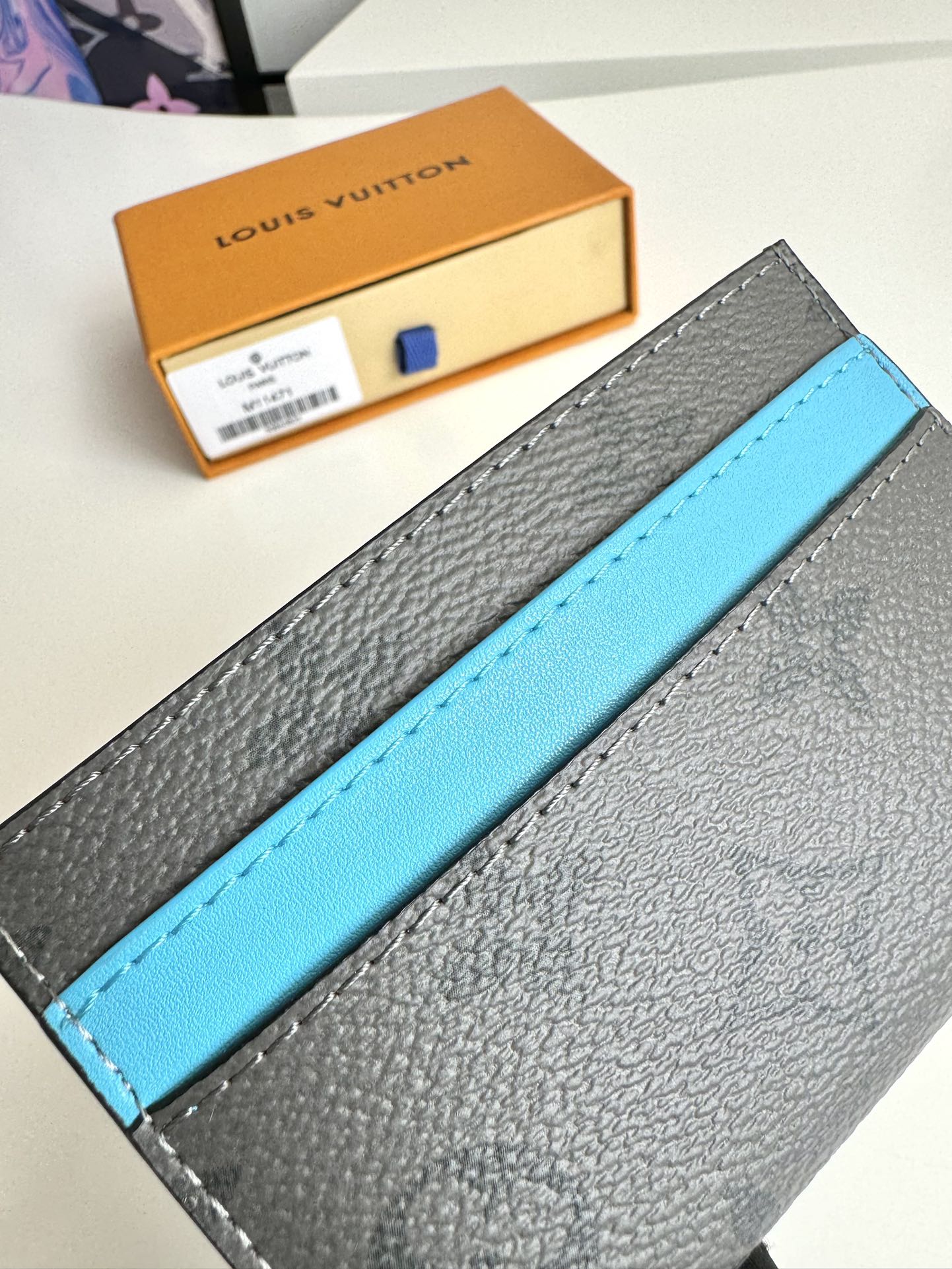 P220 M11471 This card holder is made of Monclerogram Eclipse Reverse canvas giving the Monclerogram pattern an elegant faded look and feel showing Pharrell Williams' fresh take on a classic element with a vintage Marque L.Vuitton Déposée logo on the front again paying tribute. Size: 11 x 7cm