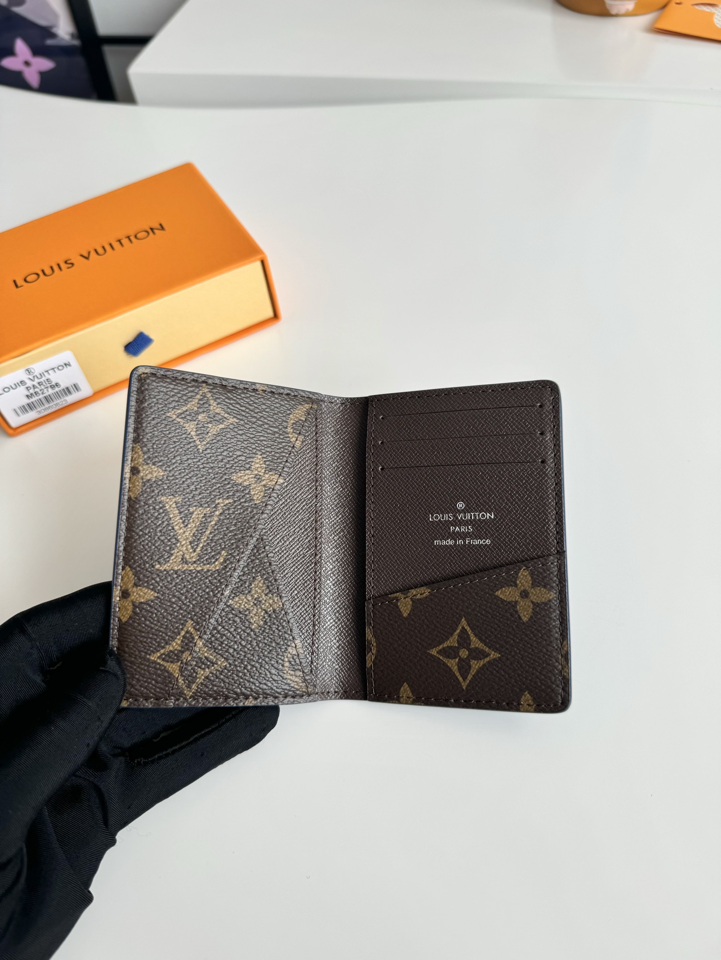 P360 M82796 This pocket wallet is made of smooth Monclerogram-coated canvas with a contrasting color lining and Louis Vuitton lettering on the side in portrait orientation. Its compact shape conceals a wealth of functions.