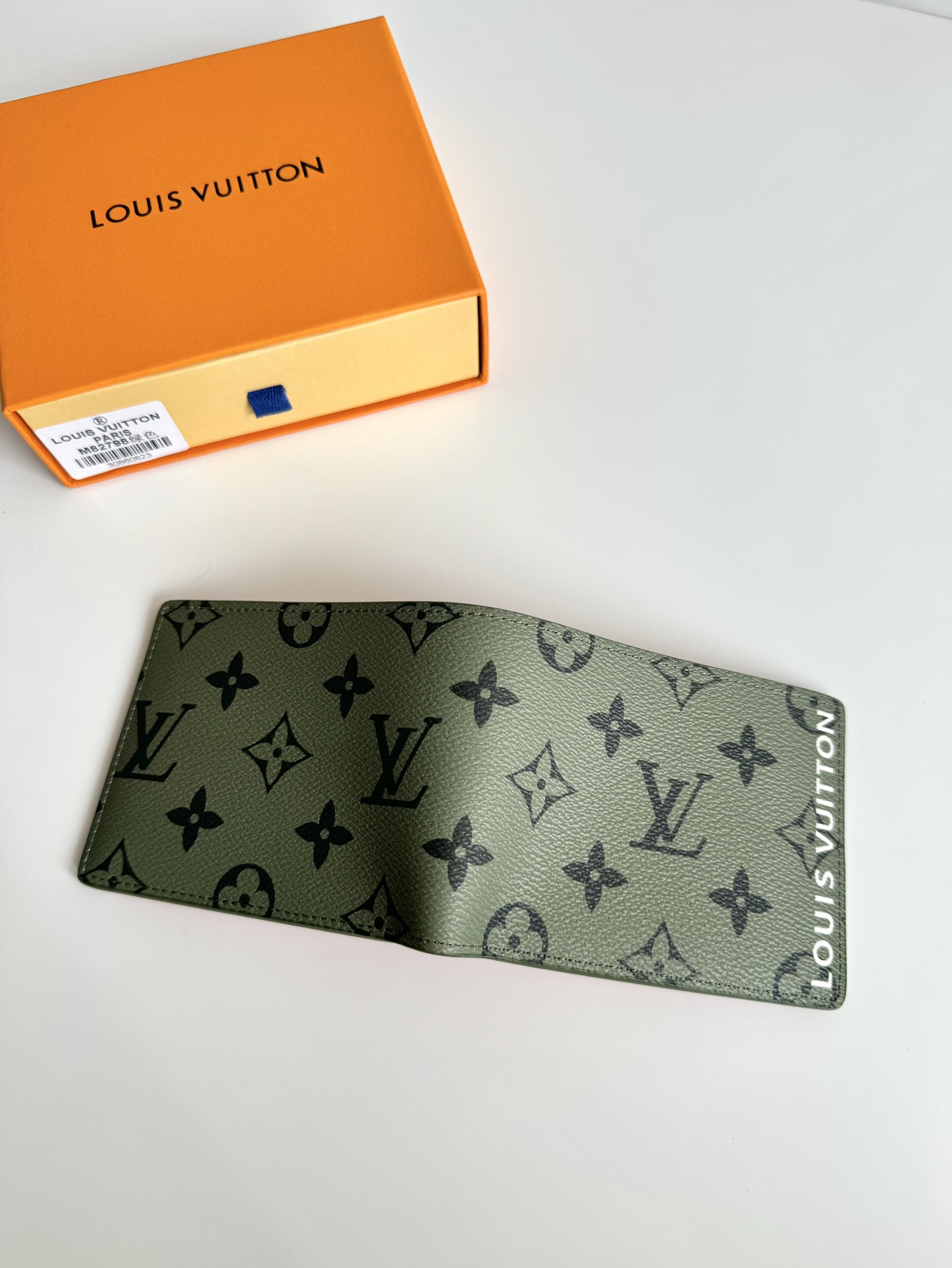 P400 M82798 This Slender wallet is made of Monclerogram canvas with a Monclerogram pattern in different shades on the inside and the Louis Vuitton logo written on the front side of the wallet.