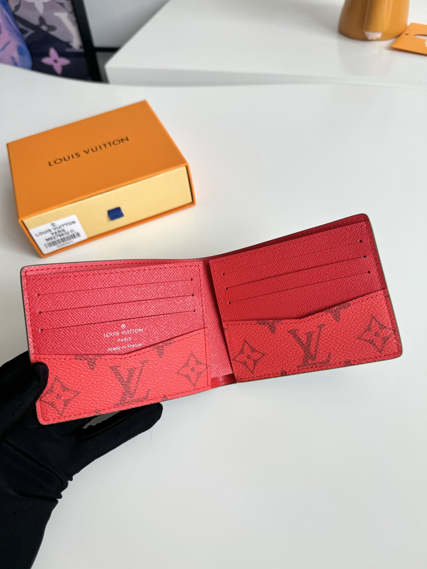 P400 M82798 This Slender wallet is made of Monclerogram canvas with a Monclerogram pattern in different shades on the inside and the Louis Vuitton logo written on the front side of the wallet.