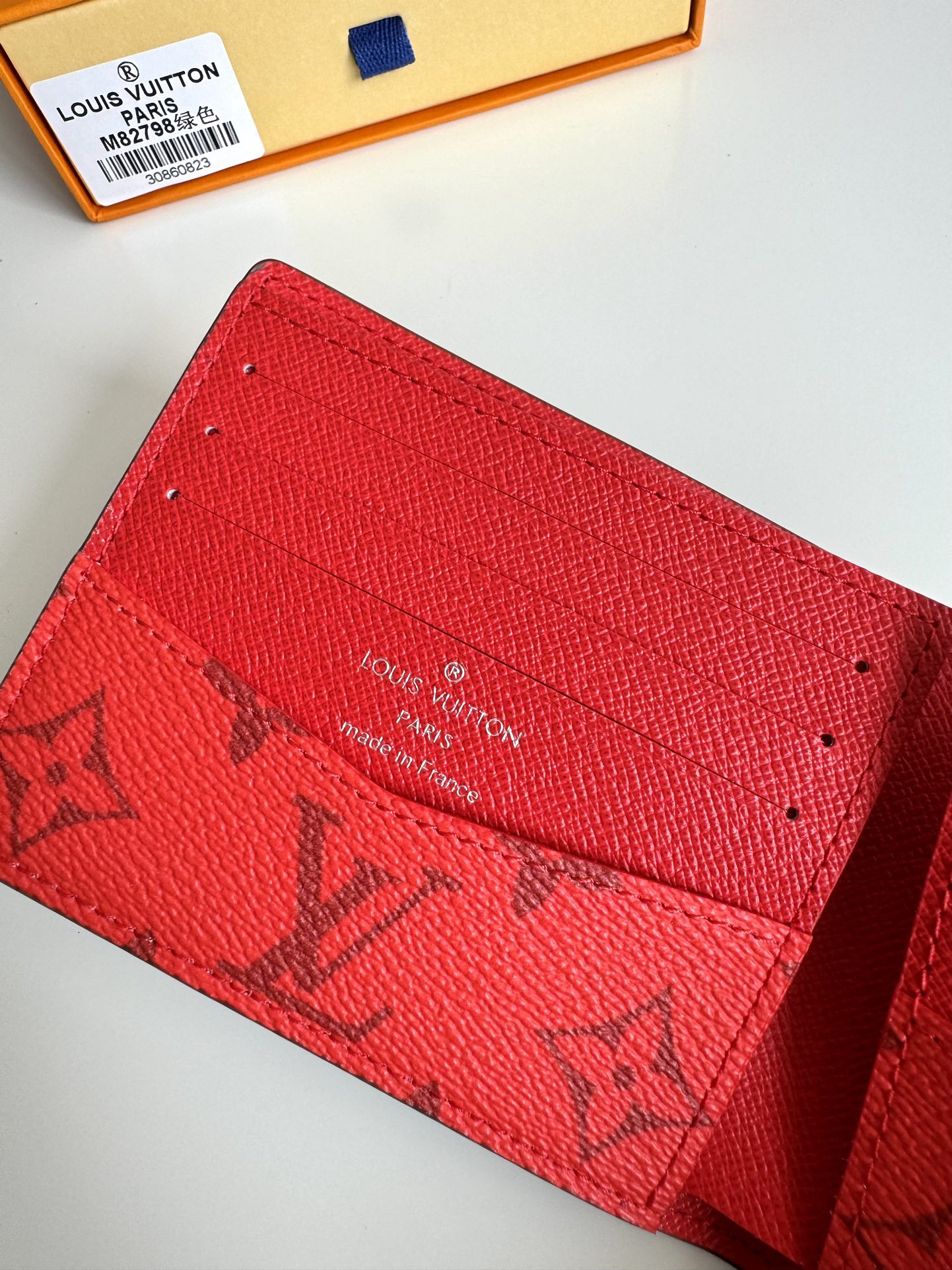 P400 M82798 This Slender wallet is made of Monclerogram canvas with a Monclerogram pattern in different shades on the inside and the Louis Vuitton logo written on the front side of the wallet.