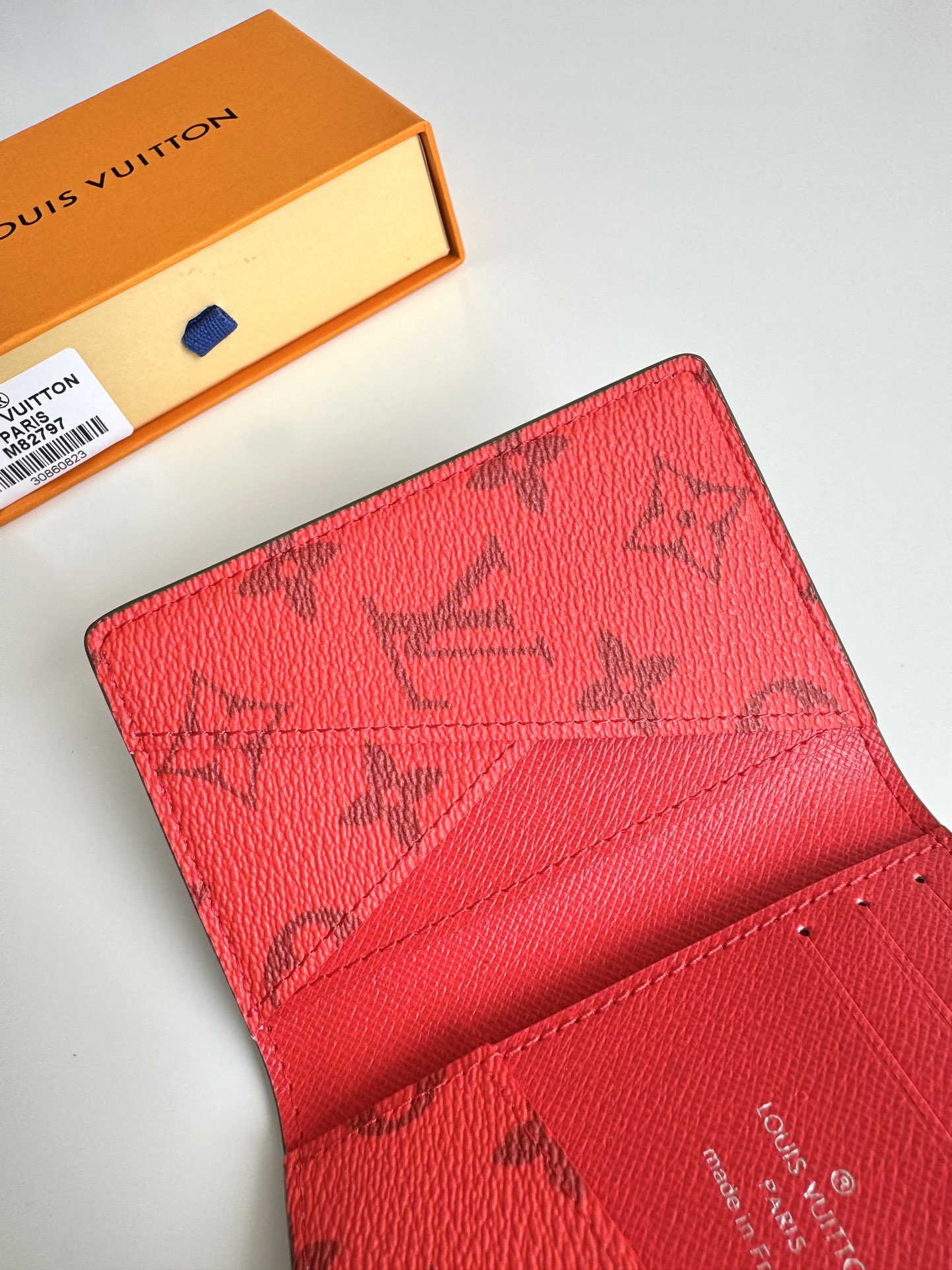 P360 M82797 This pocket wallet is made of smooth Monclerogram-coated canvas with a contrasting color lining and Louis Vuitton lettering on the side in portrait orientation. Its compact shape conceals a wealth of functions.