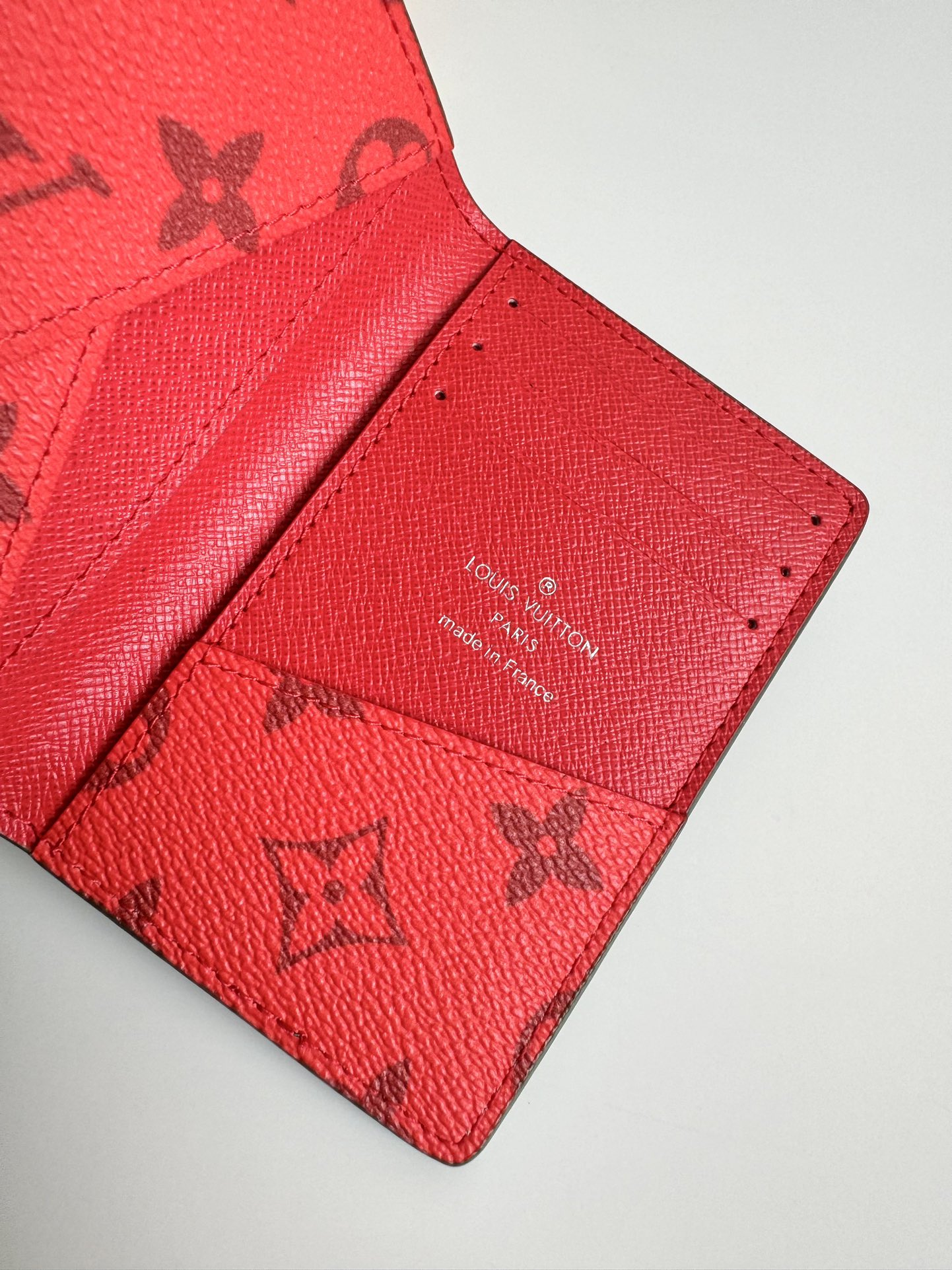 P360 M82797 This pocket wallet is made of smooth Monclerogram-coated canvas with a contrasting color lining and Louis Vuitton lettering on the side in portrait orientation. Its compact shape conceals a wealth of functions.