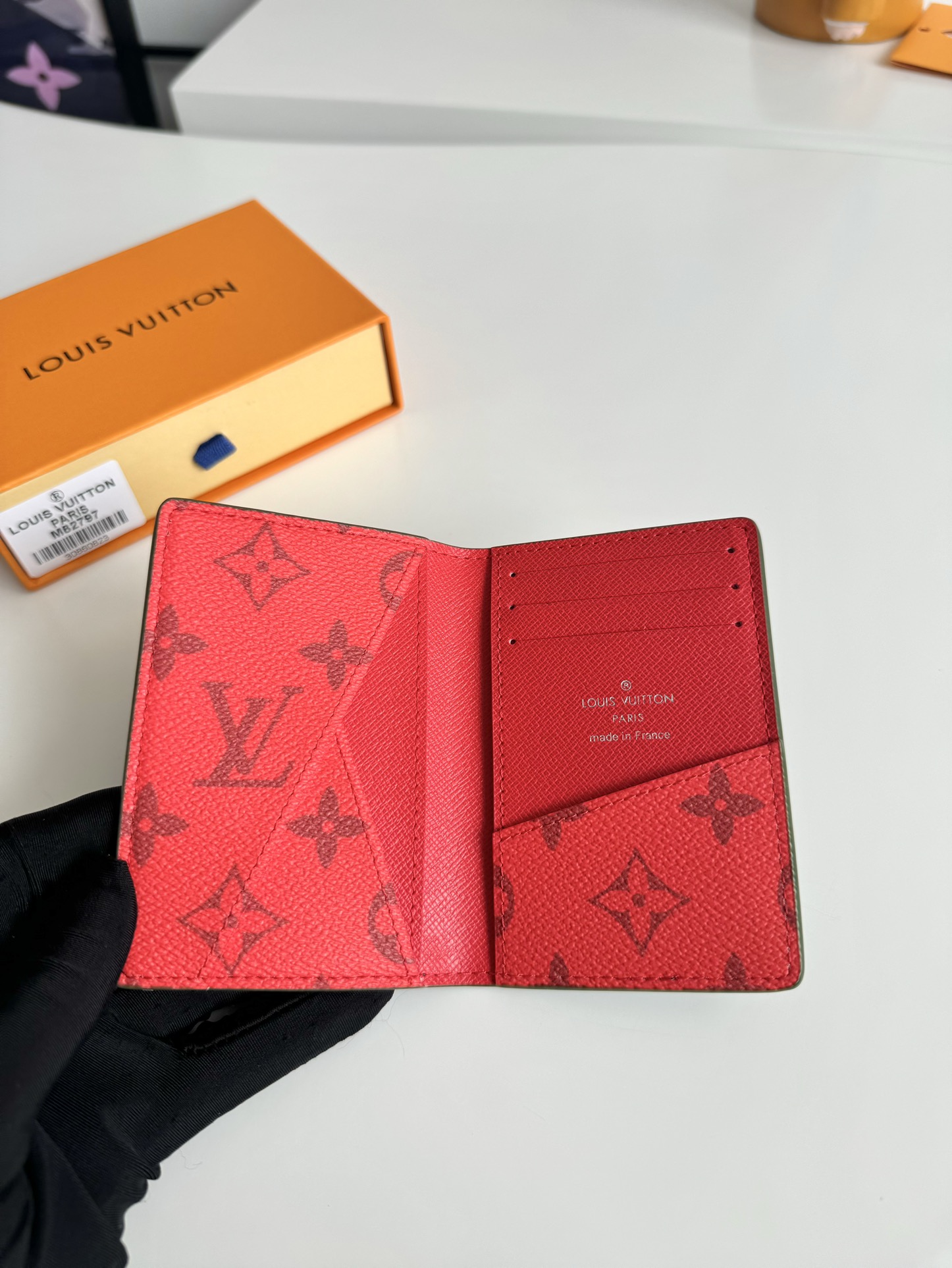 P360 M82797 This pocket wallet is made of smooth Monclerogram-coated canvas with a contrasting color lining and Louis Vuitton lettering on the side in portrait orientation. Its compact shape conceals a wealth of functions.