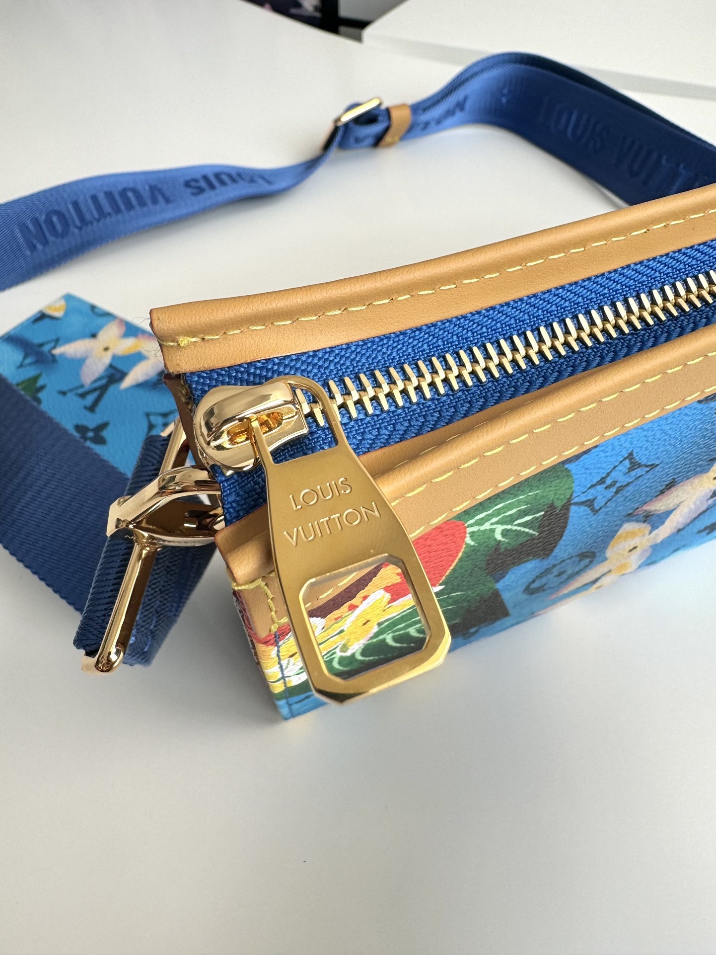 P840 M83466 Surf's Up This Gaston mini bag in Monclerogram Surfin' canvas showcases Pharrell Williams' summery take on colorful prints and is compact enough to hold a smartphone and a short money clip. Crossbody size: 22 x 14.5 x 4.5cm