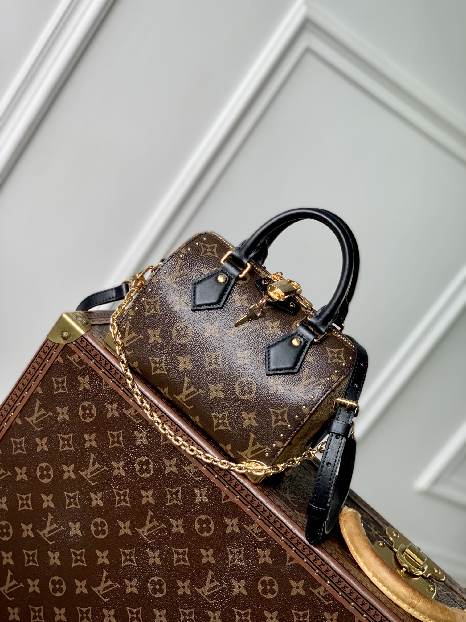 P1900 LV M13146El icónico baúl Speedy se reinterpreta en un nuevo e impactante estilo para la colección Primavera 2025.El tradicional estuche rígido con delicados detalles dorados está confeccionado con la lona Monclerogram de la marca y acabado con ribetes en contraste Monclerogram Reverse. Diseño icónico de Nicolas GhesquièreEl bolso cuenta con una bandolera desmontable y una correa de cadena que puede llevarse en diagonal, sobre el hombro o en la mano20,5 x 16 x 11 cm (L x A x A)-Bolso de alta costura