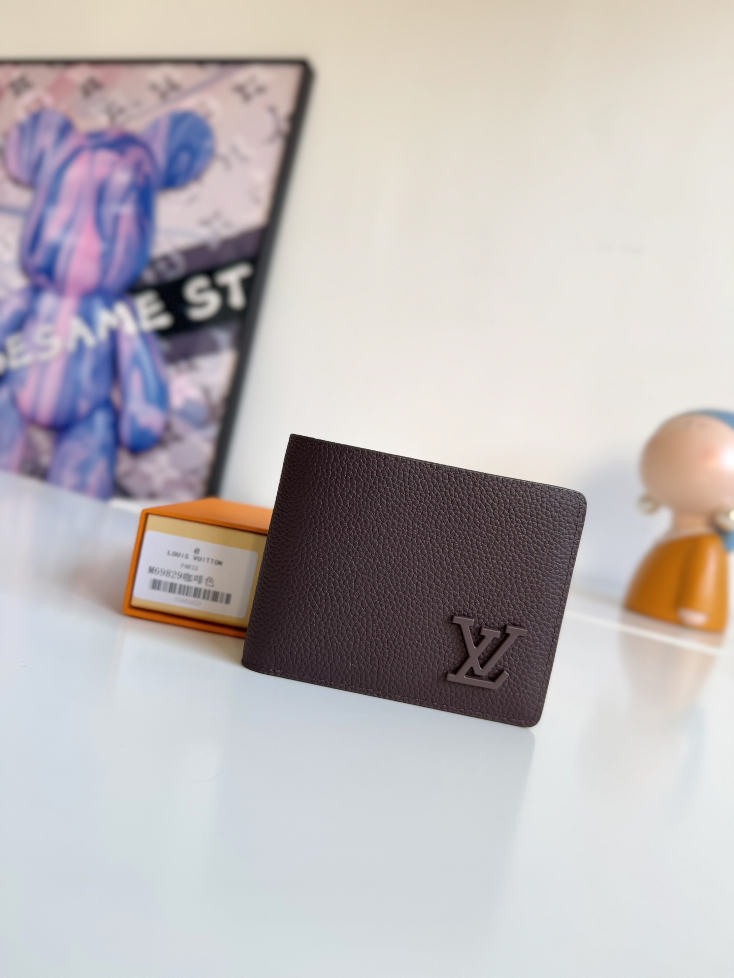 P300 M69829 Gray LV Aerogram Multiple Wallet A fresh take on a classic design, the craftsmanship gives the cowhide leather a richly grained texture Metal LV letters mark the brand's identity and can be easily worn with the LV Aerogram collection of handbags Dimensions: 11.5 x 9 x 1.5 cm.