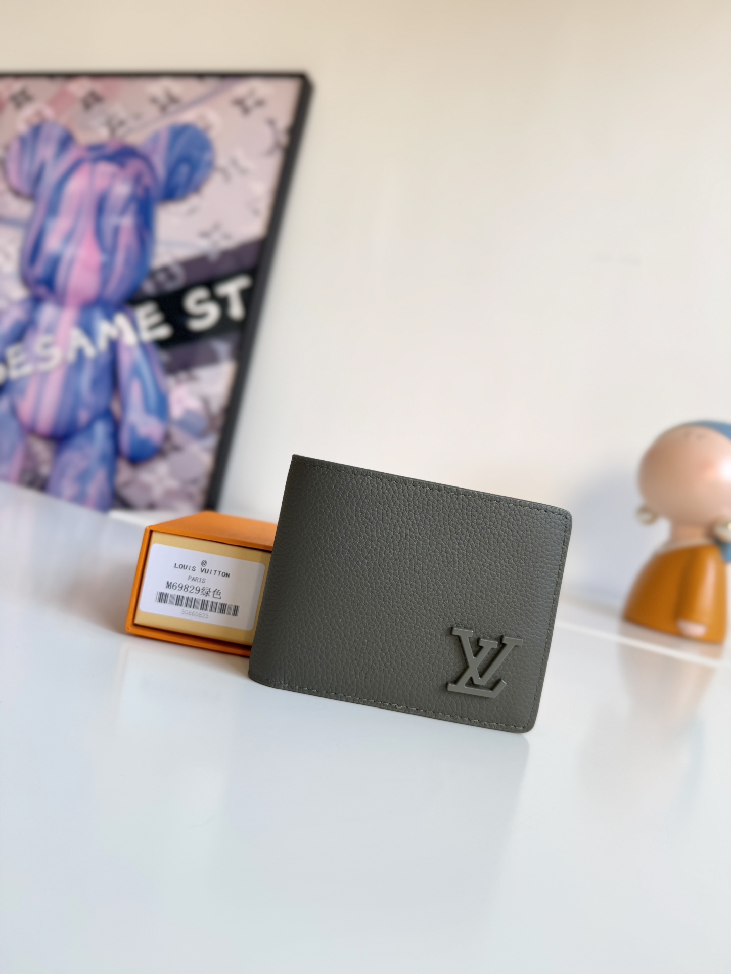 P300 M69829 Gray LV Aerogram Multiple Wallet A fresh take on a classic design, the craftsmanship gives the cowhide leather a richly grained texture Metal LV letters mark the brand's identity and can be easily worn with the LV Aerogram collection of handbags Dimensions: 11.5 x 9 x 1.5 cm.