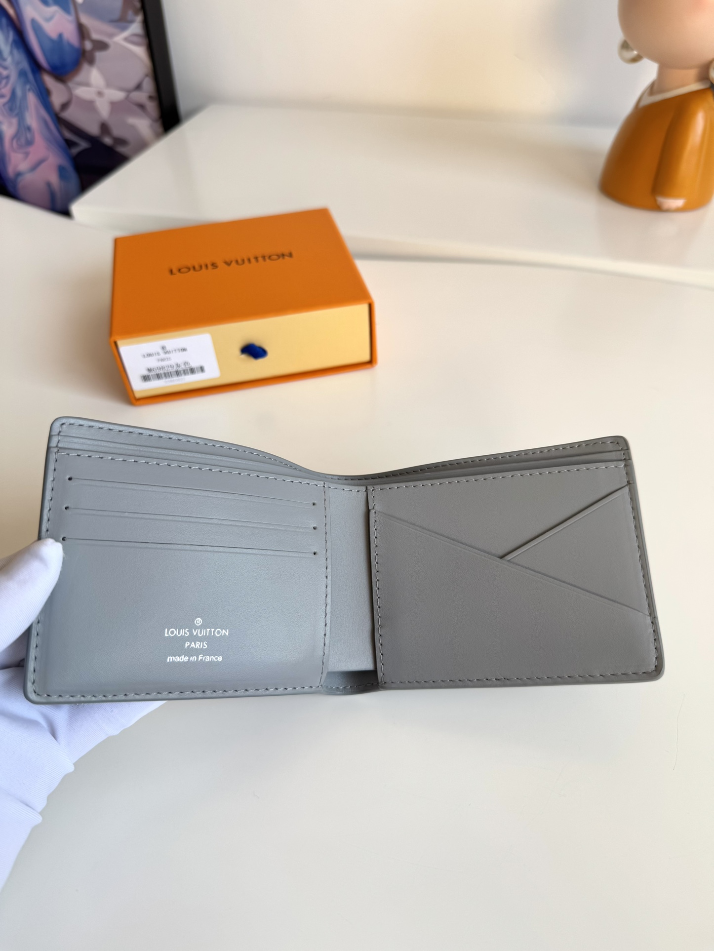 P300 M69829 Gray LV Aerogram Multiple Wallet A fresh take on a classic design, the craftsmanship gives the cowhide leather a richly grained texture Metal LV letters mark the brand's identity and can be easily worn with the LV Aerogram collection of handbags Dimensions: 11.5 x 9 x 1.5 cm.