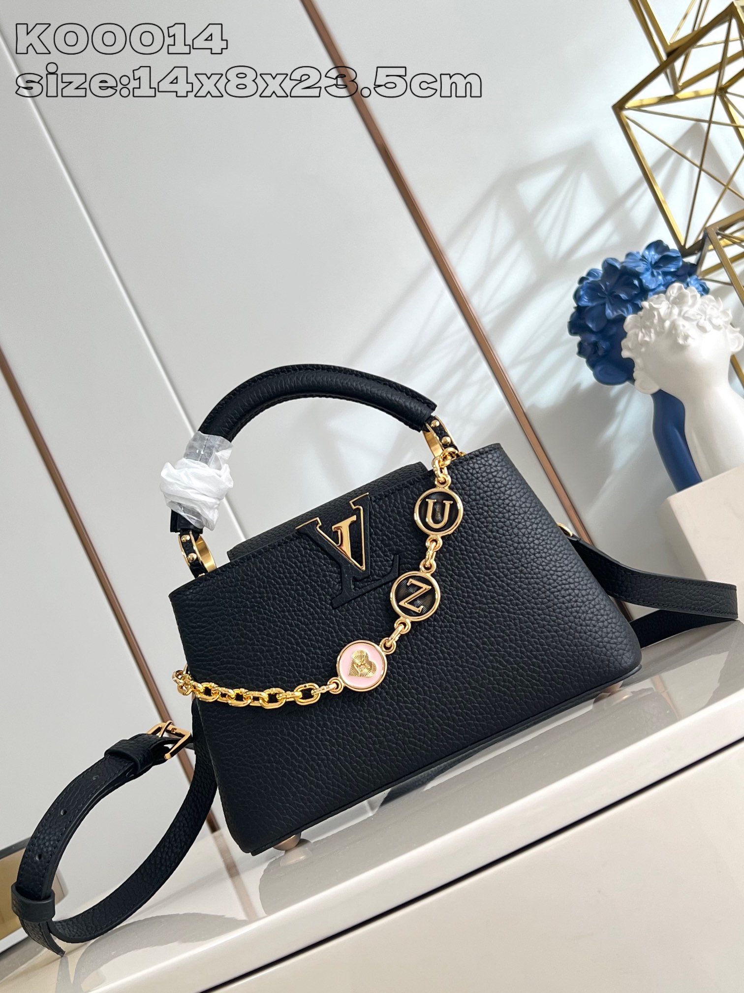 P2200 LV K00014Black La collection Capucines poursuit ses classiques avec cette version personnalisée entre les tailles Mini et BB. Choisissez d'abord votre couleur de cuir préférée, puis ajoutez la chaîne à votre guise avec trois embellissements en monogrammes doublement plaqués et des porte-bonheur de marque sur une pièce métallique sophistiquée de 14 x 8 x 23,5 cm (H x L x L).