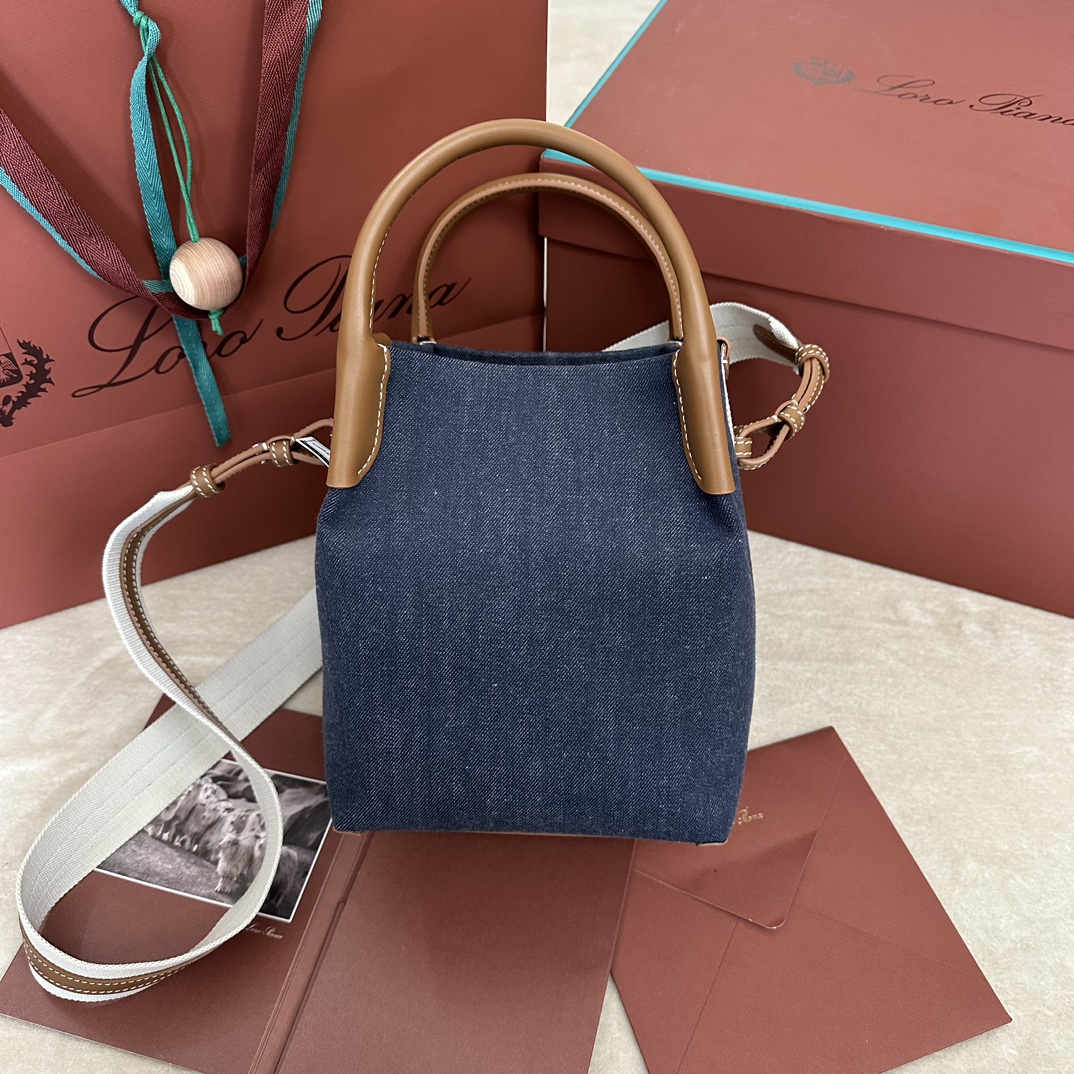 P1500Loro piana Medium Bucket Bale Medium HandbagColor : Blue DenimCe sac seau moyen est fabriqué en cuir de haute qualité inspiré par la forme chic et le nom des paquets de cachemireDouble poignéesL'intérieur est doté d'une fermeture à ongletLe côté se connecte sans couture avec une sangle en tissu transparentDémontre l'élégance et montre le style doux et sophistiquéTaille : 17✖️ ✖️✖️21CM-SACHETTES HAUTE MODE