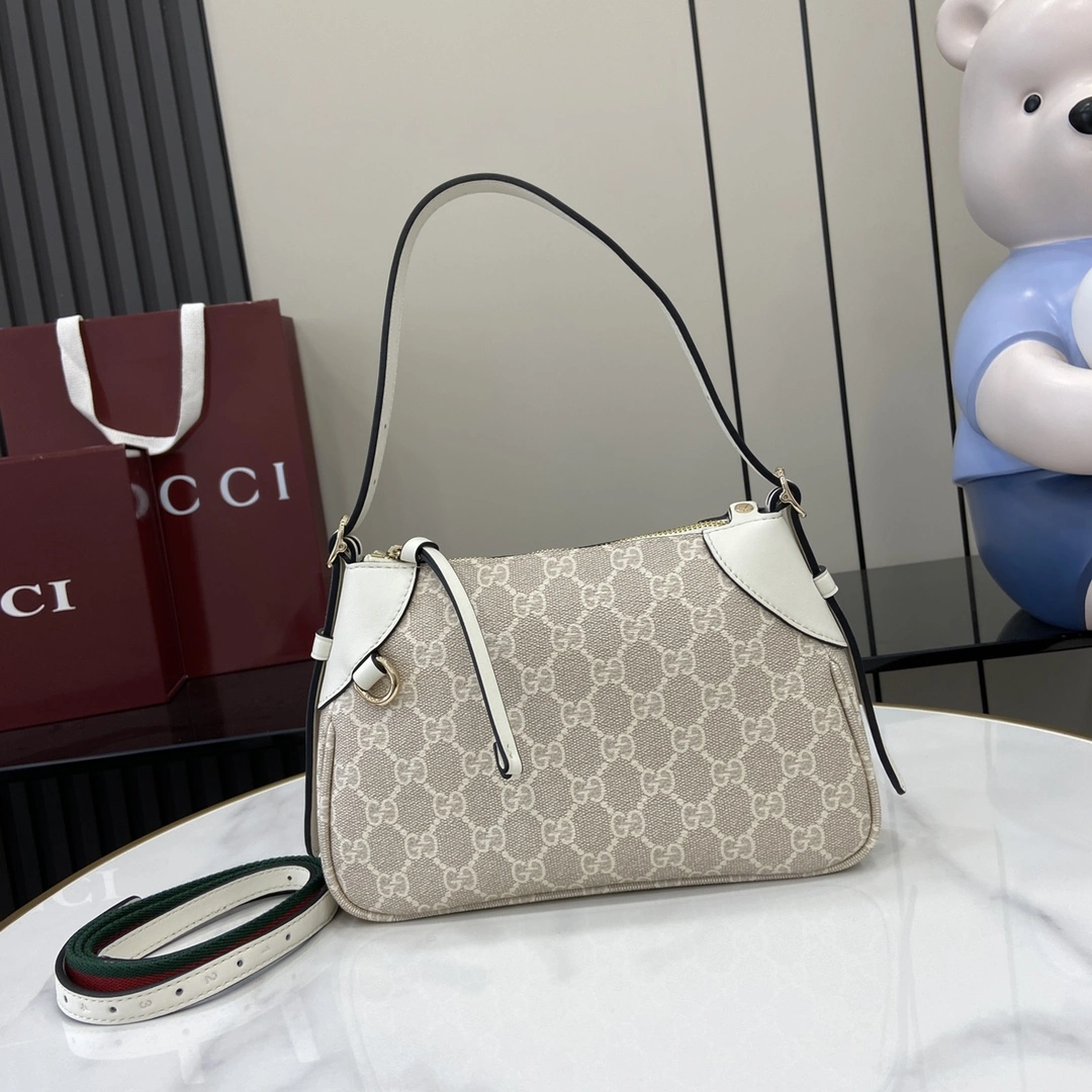 p920 Gucci Emblem系列焕新诠释品牌的隽永优雅风范和精湛工艺这款小号肩背包配有可调节肩带饰以示数孔眼灵感源自马术世界米色和白色全新GG字母图案涂层织物米白色皮革滚边饰对比色缝线另配有用于系挂可拆卸物品的D形环饰示数孔眼可调节手柄；高16厘米 – 27厘米内部：一个开口袋可调节皮革肩带（高47厘米 – 57厘米）拉链开合型号：815218尺寸：24.5厘米（宽）x 16厘米（高）x 5厘米（深）颜色：米胶米白/重量：约0.25千克意大利创作-高仿包包